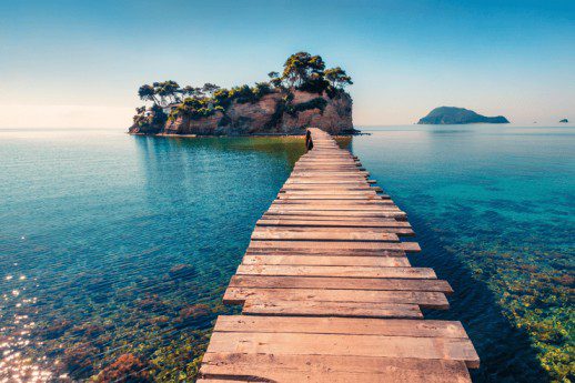 Blog 70 A wooden walkway extends out to a small tropical island.