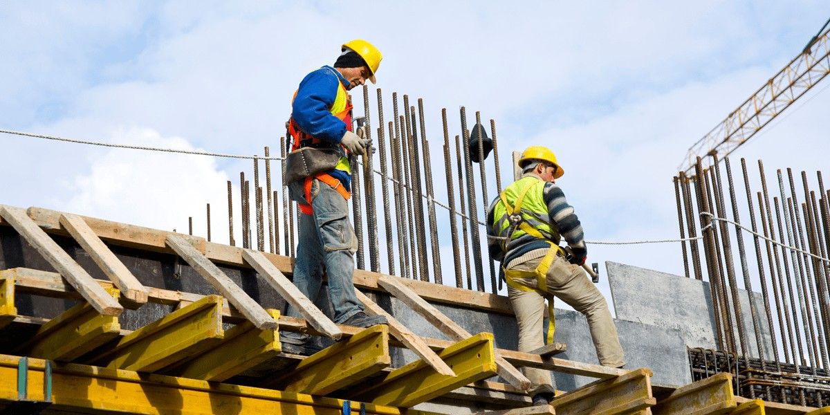 Blog 40 Two engineers in hard hats work on a construction project.
