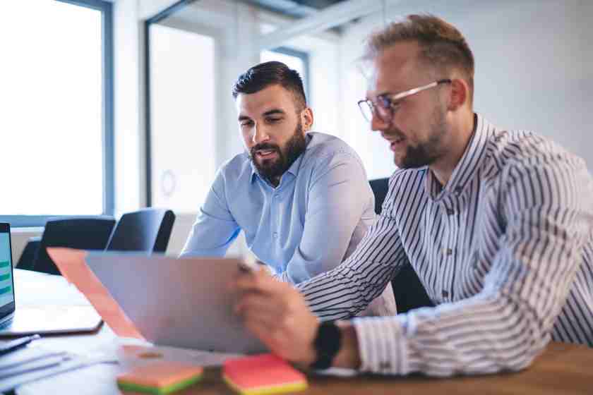 Hire2Retire Phase 5.1: ITSM Integration, Enhanced Change Tracking, and More 1 Two businessmen reviewing information on a tablet.