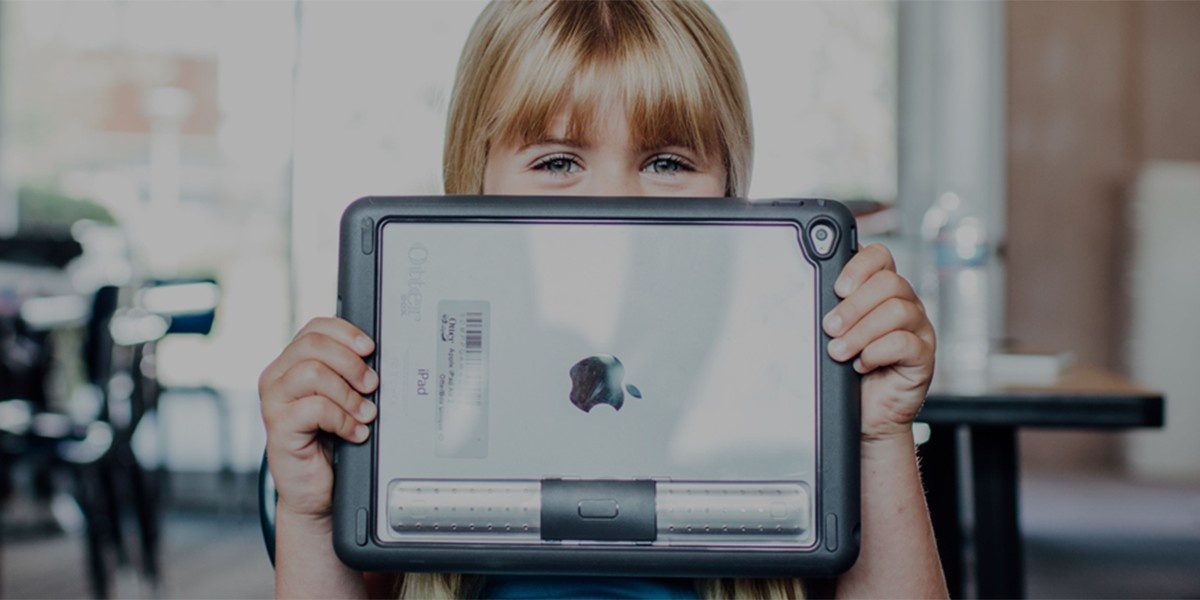 Blog 43 A young child holds a tablet with a protective case.