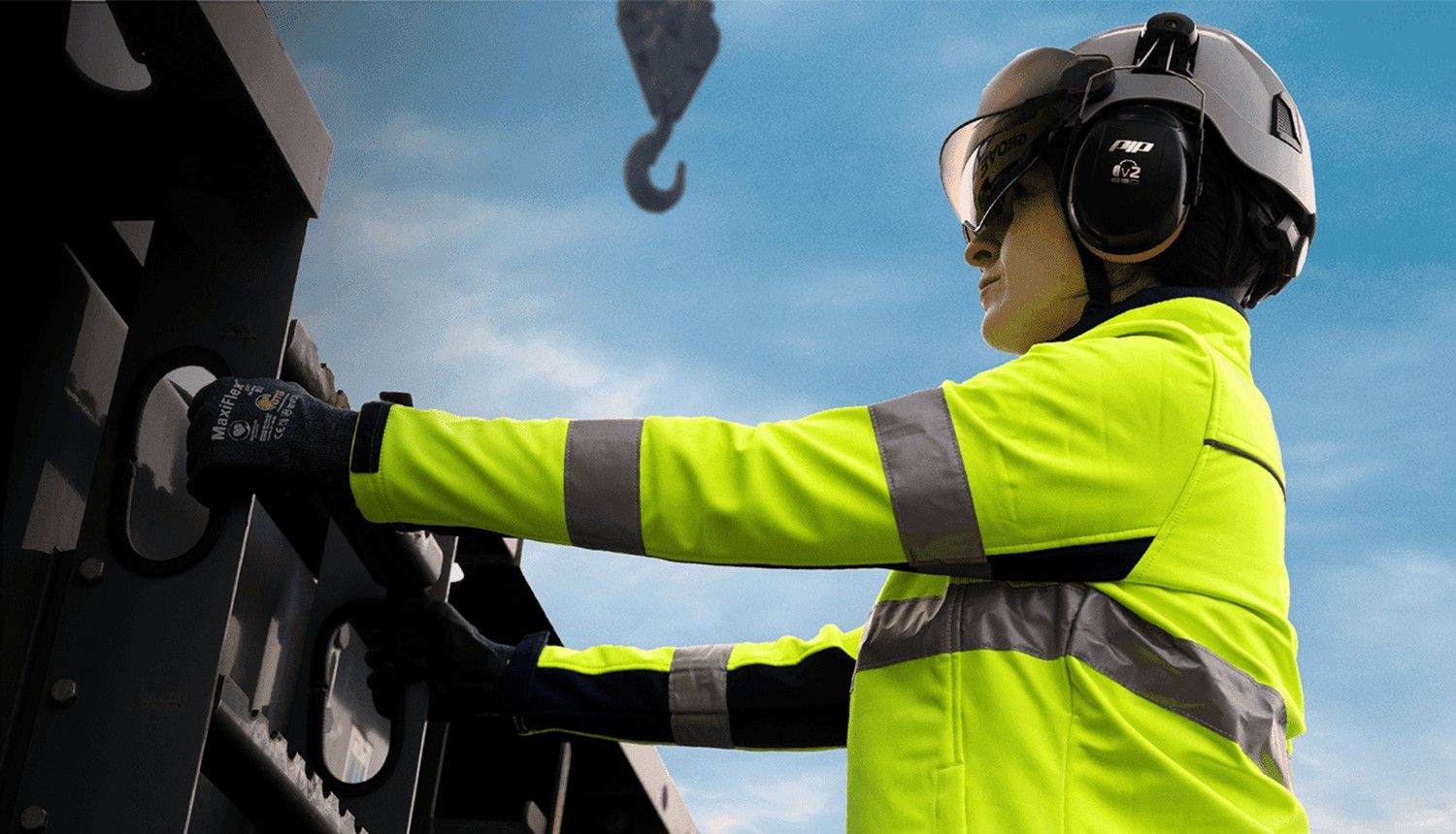 Blog 39 A woman in a high-vis jacket and hard hat works on a construction project.