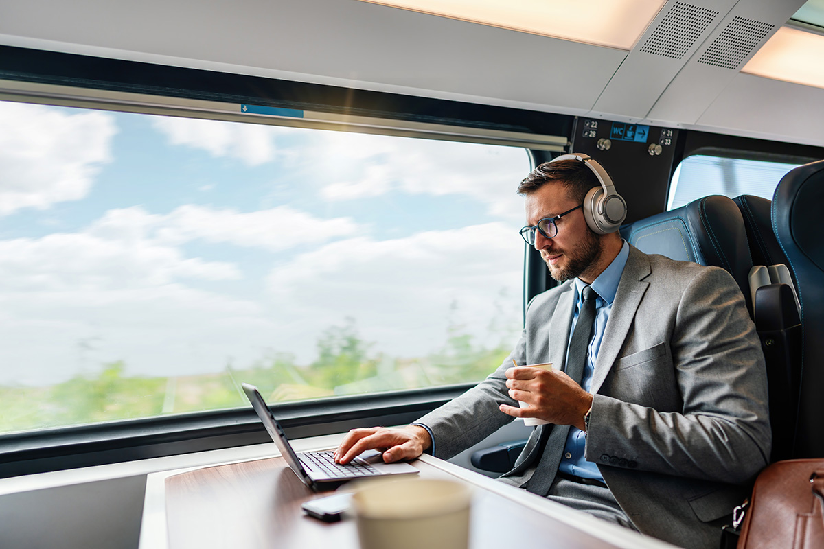 Businessman on a train working on his computer