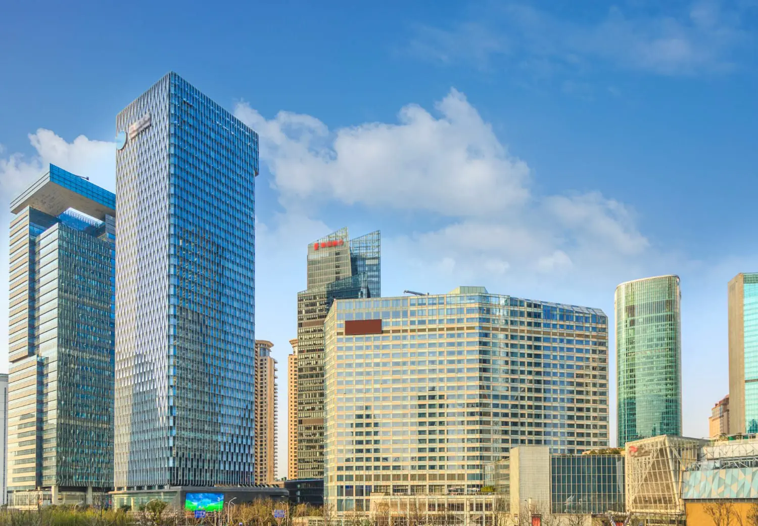 Hire2Retire Phase 6.5: Oracle PeopleSoft Support, Paycom Onboarding, new Service Desk options, and more 1 Ground shot of skyscrapers in a city skyline.