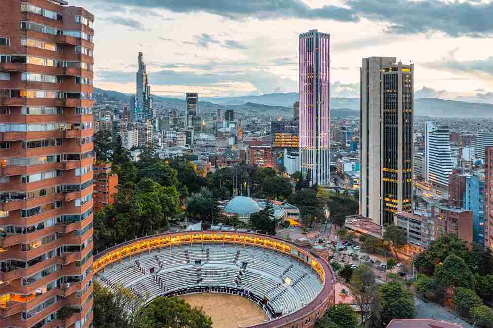 Blog 49 Aerial shot of the Bogota city skyline with a sports stadium in the foreground.