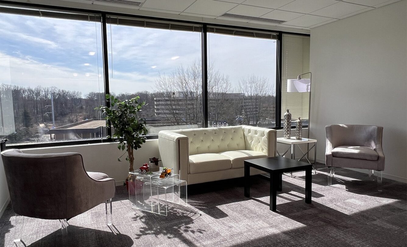 The interior of RoboMQ's Northern Virginia office. a lounge area with a large window in the background.
