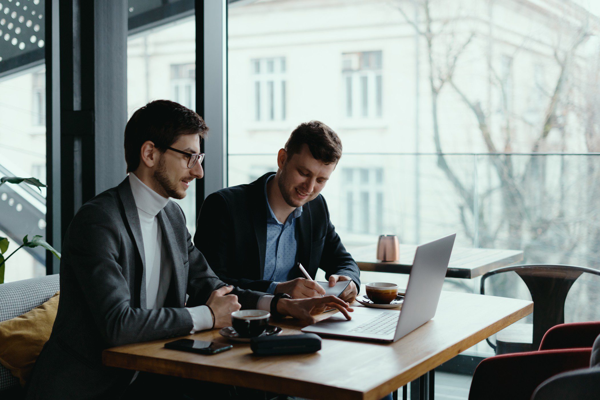 How To Homepage 1 Two young businessman having successful meeting at restaurant discussing Hire2Retire's Ceridian to Okta Directory integration