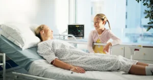 Smile, child and visit mother at hospital for support, medical recovery, and post surgery after Nevada Donor Network's help